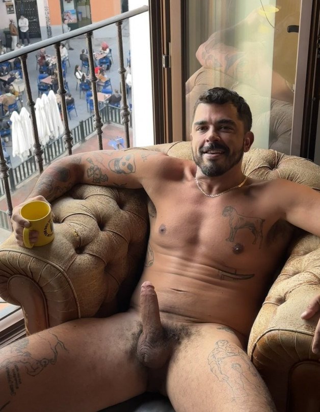 Photo by Nickplus33 with the username @Nickplus33, who is a verified user,  June 9, 2024 at 2:41 AM and the text says '#manspread  #coffee #dilf #ink #smooth #spear #bush #chain'