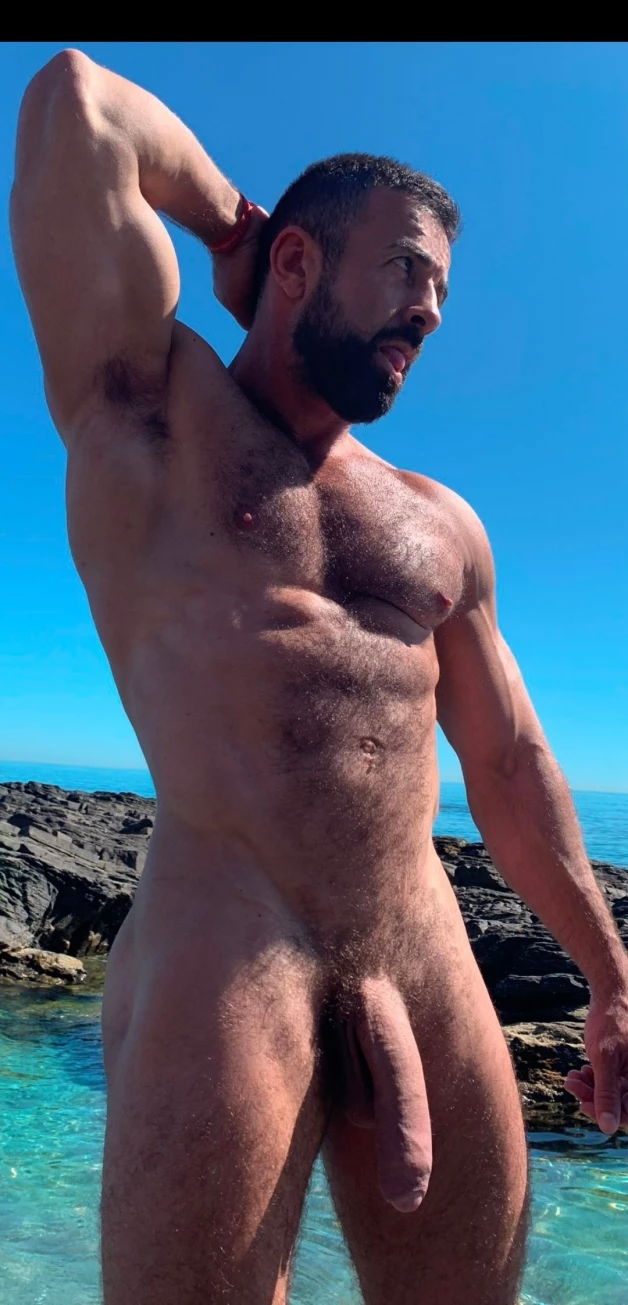 Photo by Nickplus33 with the username @Nickplus33, who is a verified user,  April 14, 2024 at 4:10 AM and the text says '#muscled #beard #hairy #hairychest #daddy #bush #hung #longdick #uncut  #tongue #outdoors'