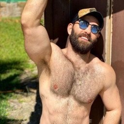 Photo by Nickplus33 with the username @Nickplus33, who is a verified user,  April 30, 2024 at 1:10 AM and the text says '#dilf #shades #beard #caps #outdoors #hairy #hairychest #toned'