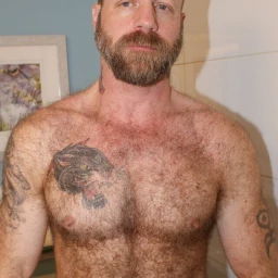 Photo by Nickplus33 with the username @Nickplus33, who is a verified user,  March 25, 2024 at 4:00 AM and the text says '#toned #hairy #beard #daddy #dilf #ink #bald #ginger'