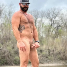 Photo by Nickplus33 with the username @Nickplus33, who is a verified user,  April 7, 2024 at 3:38 AM and the text says '#dilf #outdoors #caps #beard #shades #beefy #hairy #chain #bush #ink'