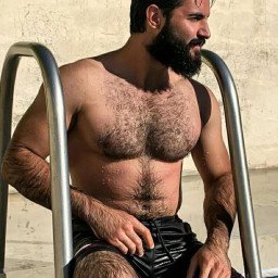 Photo by Nickplus33 with the username @Nickplus33, who is a verified user,  April 25, 2024 at 2:15 AM and the text says '#beard #hairy #dilf #outdoors #pool #toned'