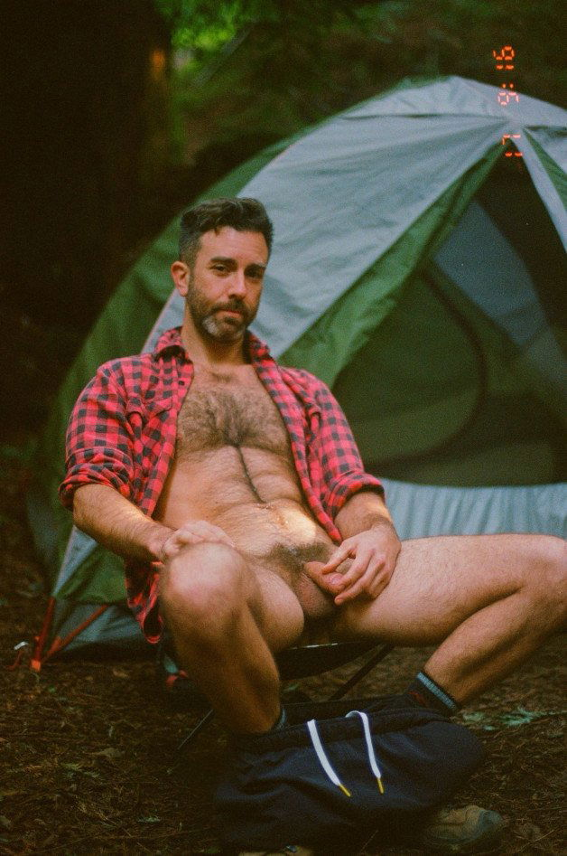 Photo by Nickplus33 with the username @Nickplus33, who is a verified user,  May 23, 2024 at 12:44 AM and the text says '#dilf #manspread  #outdoors #hairy #hairychest #happytrail #bush #balls'