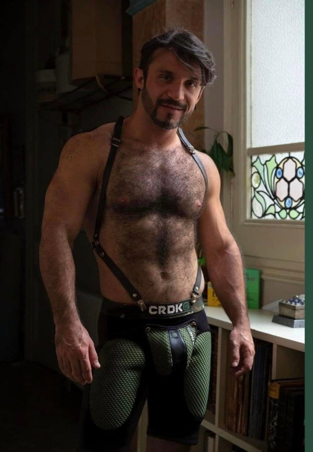 Photo by Nickplus33 with the username @Nickplus33, who is a verified user,  March 13, 2024 at 3:22 AM and the text says '#hairy #dilf #beard #beefy #bulge #leather #harness'