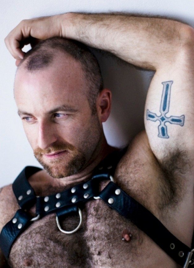 Photo by Nickplus33 with the username @Nickplus33, who is a verified user,  April 28, 2024 at 2:51 AM and the text says '#harness #dilf #beard #dimple #leather #scruff  #hairy #hairychest'