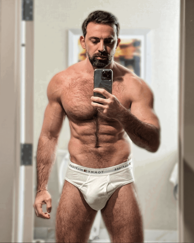 Photo by Nickplus33 with the username @Nickplus33, who is a verified user,  February 4, 2024 at 5:43 AM and the text says '#selfies #hairy #dilf #beard #bulge #tightywhities #toned'