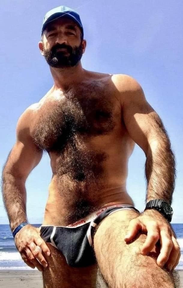 Photo by Nickplus33 with the username @Nickplus33, who is a verified user,  March 13, 2024 at 3:19 AM and the text says '#caps #hairy #daddy #outdoors #dilf #beard #beach #outdoors #toned'