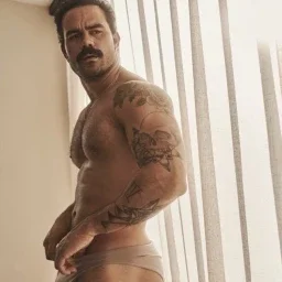 Photo by Nickplus33 with the username @Nickplus33, who is a verified user,  May 3, 2024 at 3:20 AM and the text says '#dilf #tanned #stache #ink #muscled #toned #bulge'