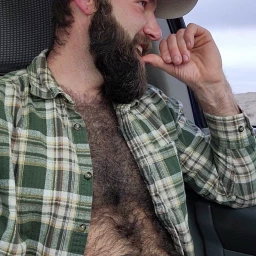 Photo by Nickplus33 with the username @Nickplus33, who is a verified user,  May 9, 2024 at 3:15 AM and the text says '#caps #dilf #youngdilf #hairy #car #beard'