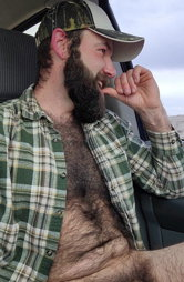 Photo by Nickplus33 with the username @Nickplus33, who is a verified user,  May 9, 2024 at 3:15 AM and the text says '#caps #dilf #youngdilf #hairy #car #beard'