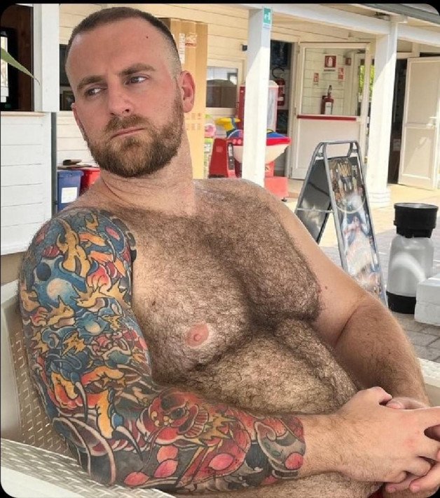 Photo by Nickplus33 with the username @Nickplus33, who is a verified user,  May 27, 2024 at 2:27 AM and the text says '#bear #hairy #beefy #beard #ink #dilf'