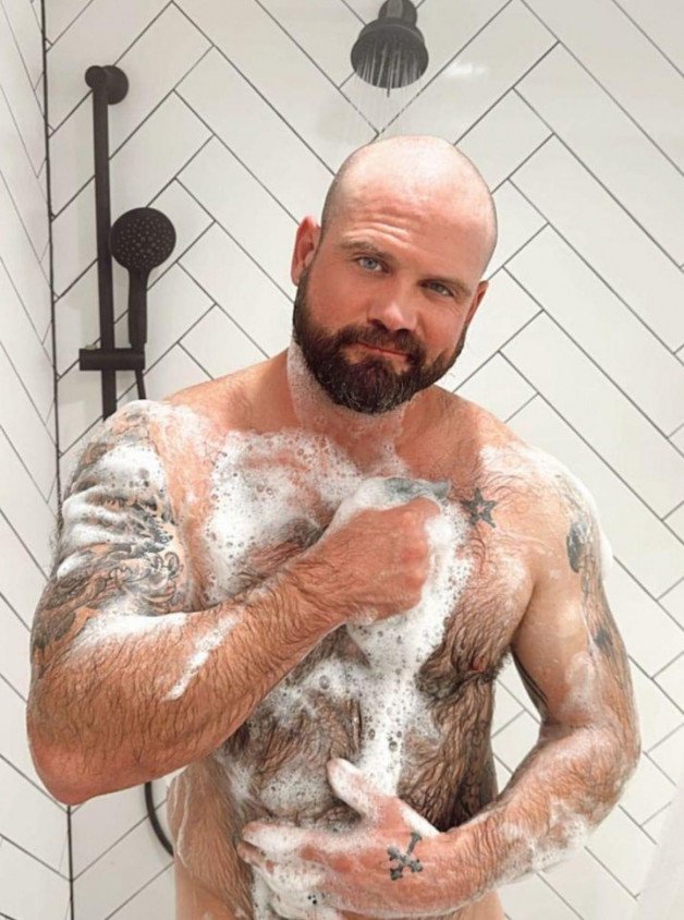 Photo by Nickplus33 with the username @Nickplus33, who is a verified user,  May 18, 2024 at 4:29 AM and the text says '#hairy #beefy #shower #bald #dilf #beard #bear'