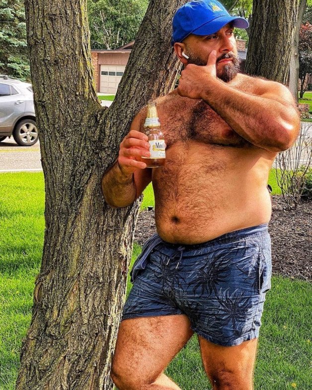 Photo by Nickplus33 with the username @Nickplus33, who is a verified user,  May 27, 2024 at 2:25 AM and the text says '#beefy #outdoors #hairy #daddy #bear #beard #caps #hairy'