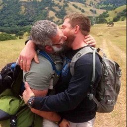 Photo by Nickplus33 with the username @Nickplus33, who is a verified user,  October 1, 2023 at 4:36 AM and the text says '#daddy #kissing #cruisingoutdoors #outdoorcruising #beard #dilf #bromance #DL #specs'