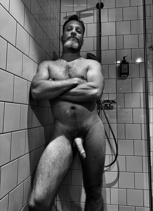 Photo by Nickplus33 with the username @Nickplus33, who is a verified user,  June 16, 2024 at 2:43 AM and the text says '#beard #beefy #shower #hung #bush #thickbush #daddy #uncut  #dilf #blackandwhite'