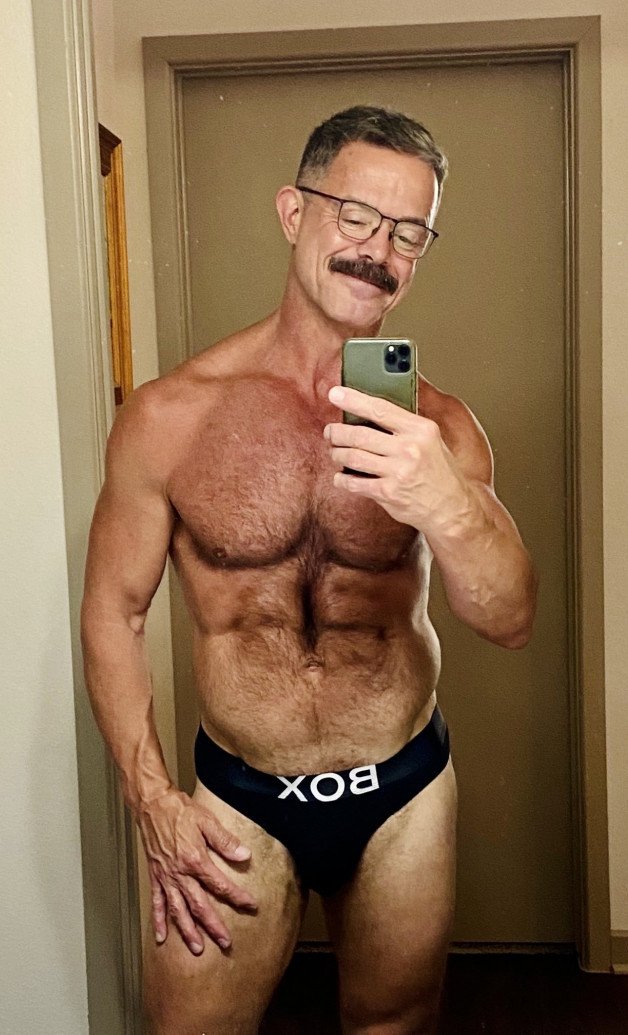 Album by Nickplus33 with the username @Nickplus33, who is a verified user,  December 10, 2023 at 5:29 AM and the text says '#series #obsession #daddy #muscled #stache #hairy #selfies #reecescott'