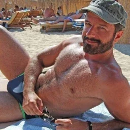 Photo by Nickplus33 with the username @Nickplus33, who is a verified user,  April 1, 2024 at 3:30 AM and the text says '#dilf #daddy #beard #outdoors #caps #hairy #hairychest #beach'