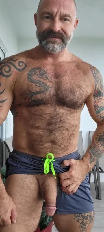 Photo by Nickplus33 with the username @Nickplus33, who is a verified user,  May 4, 2024 at 3:25 AM and the text says '#reveal #daddy #beard #toned #hairy #hairychest #longdick #hung #ink'