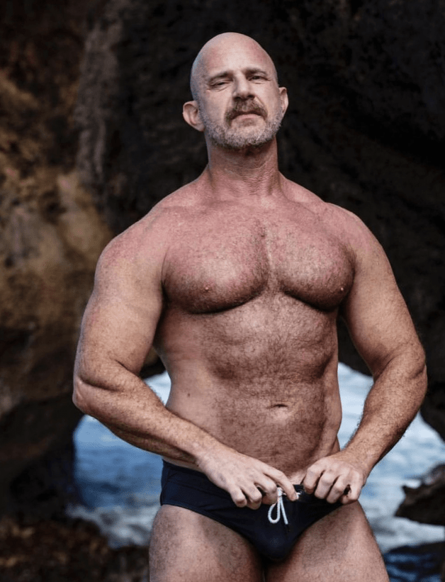 Photo by Nickplus33 with the username @Nickplus33, who is a verified user,  December 31, 2023 at 5:44 AM and the text says '#daddy #bald #toned #trimmed #hairy #speedos'