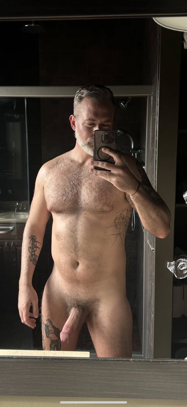 Photo by Nickplus33 with the username @Nickplus33, who is a verified user,  April 14, 2024 at 4:00 AM and the text says '#selfie #daddy #hairychest #hairy #beard #hung #thickdick #trimmed  #ink'