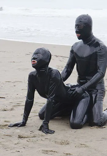 Photo by LatexAngel with the username @LatexAngel, who is a star user,  July 1, 2015 at 3:01 PM and the text says 'After all, that&rsquo;s why God created beaches&hellip; and #LatexBiches. :) #BlackLatexCatsuit #fetish #LatexMask #LatexGloves:    ow.ly/NSEM6'