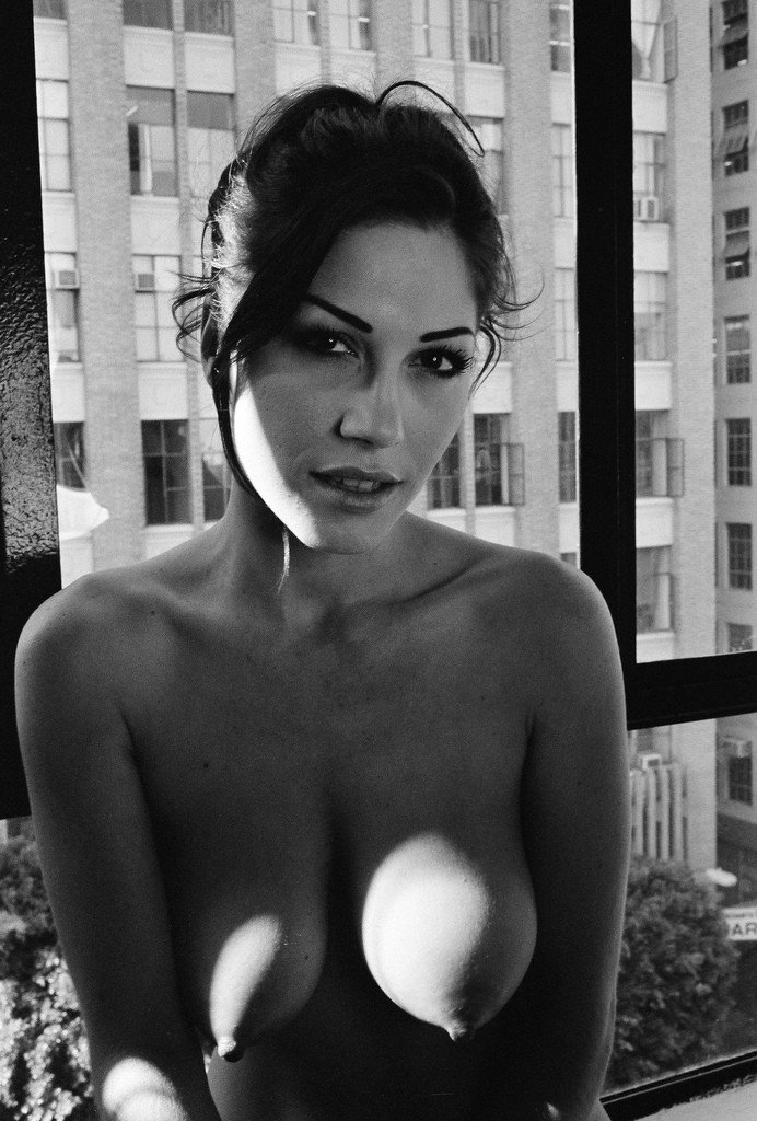 Photo by Sable with the username @SablexXx, who is a verified user,  September 27, 2011 at 2:10 PM and the text says '#tits  #face  #and  #tits  #hanging  #tits  #b&amp;w  #hair  #up  #morenas  #beautiful  #eyes  #nipples  #big  #tits  #by  #the  #window  #240  #looking  #to  #the  #camera'