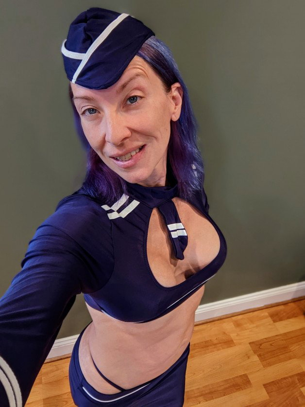 Photo by SexWithMilfStella with the username @SexWithMilfStella, who is a star user,  August 19, 2022 at 12:00 PM. The post is about the topic Cosplay and the text says 'Do not make me use my Flight Attendant voice... #milfstella #milf #altmilf #mature #cougar #girlnextdoor #hotmom #hotwife #blueeyes #cosplay #flightattendant #fit #petite #purplehair #ddds'