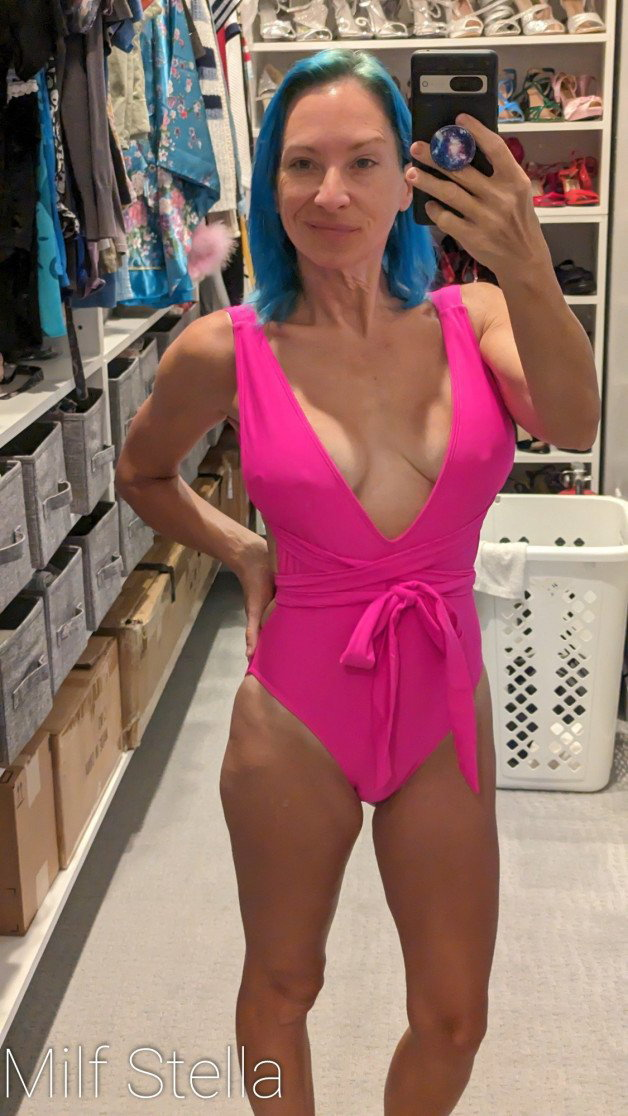 Photo by SexWithMilfStella with the username @SexWithMilfStella, who is a star user, posted on December 21, 2023. The post is about the topic MILF NEXT DOOR and the text says 'Barbie Pink really makes my hair pop! #stellahere #petite #blueeyes #bluehair #barbiepink #onepiece #swimsuit'