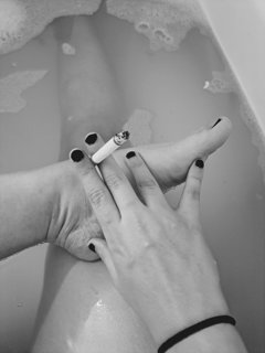 Photo by ValerieRayne with the username @ValerieRayne, who is a star user,  June 5, 2024 at 7:19 PM. The post is about the topic Foot Worship and the text says 'Feet in black and white with a smoke in the bath  - it's so sensual 🖤'