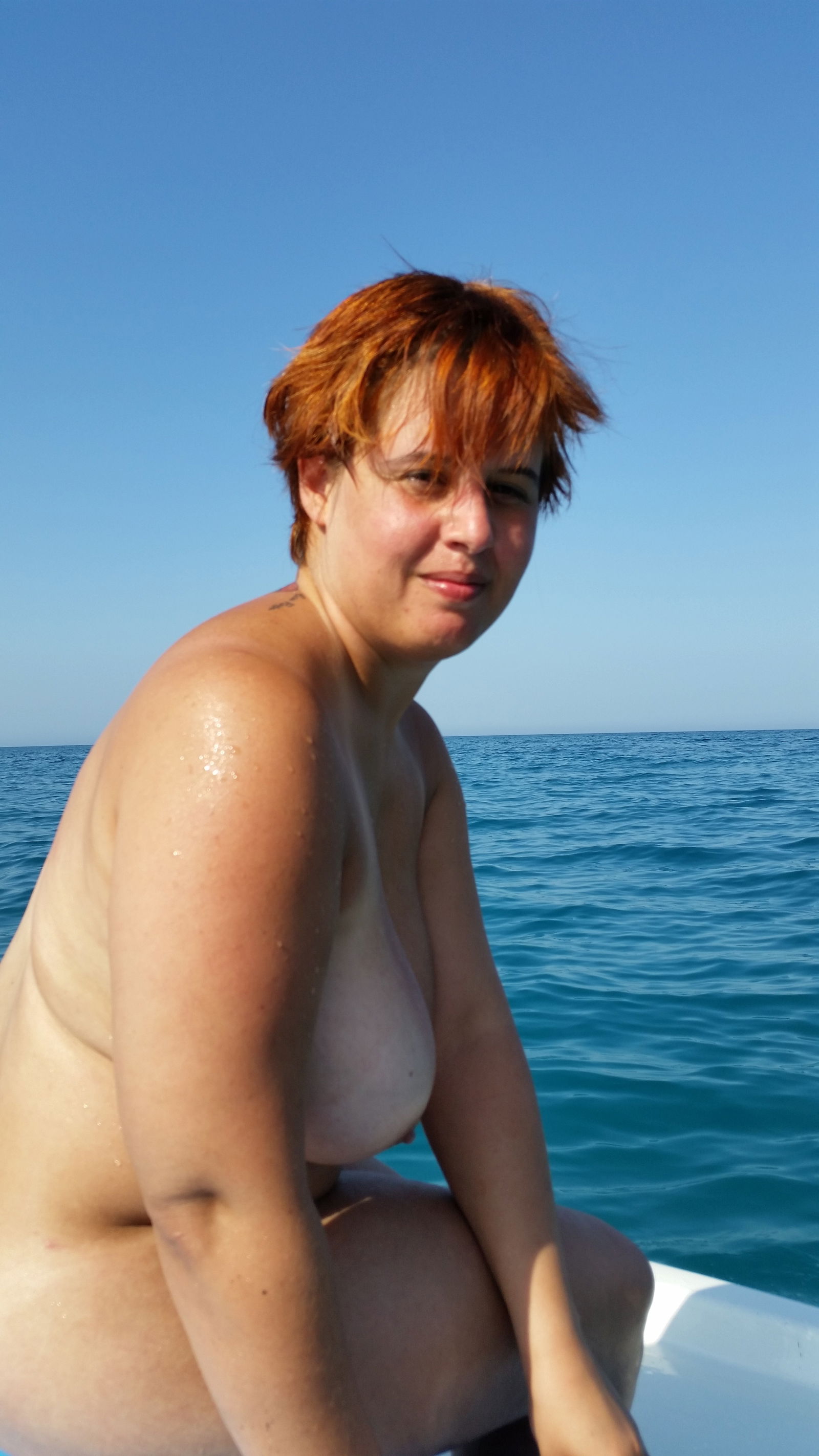 Album by OurSecretPlace with the username @OurSecretPlace, who is a verified user,  June 18, 2020 at 10:28 AM. The post is about the topic Naked in public and the text says 'Vacation on pedal boat, beachside! 
#vacation #wife #realcouple #naked by beach #expose #swim #masturbate'