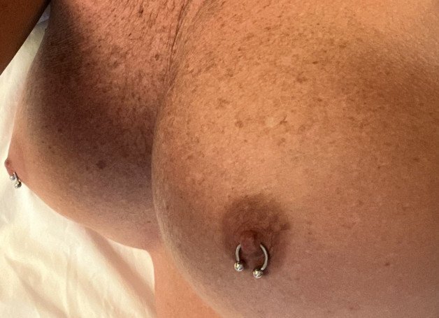 Photo by Islandgirl with the username @Islandvixen, who is a verified user, posted on October 19, 2023. The post is about the topic Pierced Nipples and the text says 'Like my tits?'