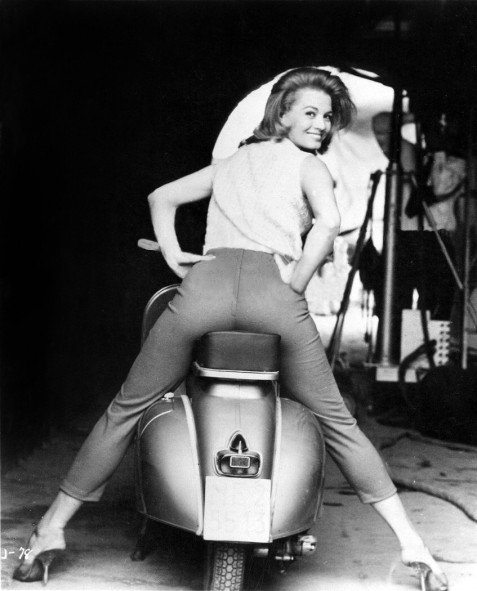Photo by nudes-des-artiste with the username @nudes-des-artiste,  March 16, 2020 at 12:51 PM. The post is about the topic Smile and the text says 'This is the last image in this Angie Dickinson set.

A fantastic looking Angie on a scooter on a sound stage somewhere in Hollywood - probably on the Universal lot, where she made a lot of movies. Her dazzling smile and beautiful face don’t distract..'