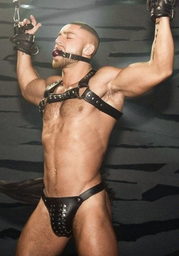 Muscular Man Wearing Black Leather BDSM And Hat.