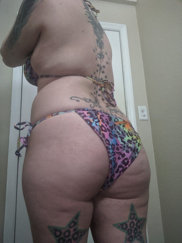 Photo by VesperaSage with the username @VesperaSage, who is a star user,  July 6, 2023 at 8:38 PM and the text says 'Which bikini is your fave? #bikini #tattoos #thick'