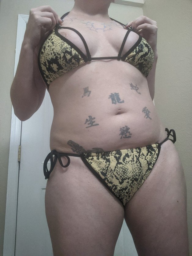 Album by VesperaSage with the username @VesperaSage, who is a star user,  July 6, 2023 at 8:38 PM and the text says 'Which bikini is your fave? #bikini #tattoos #thick'