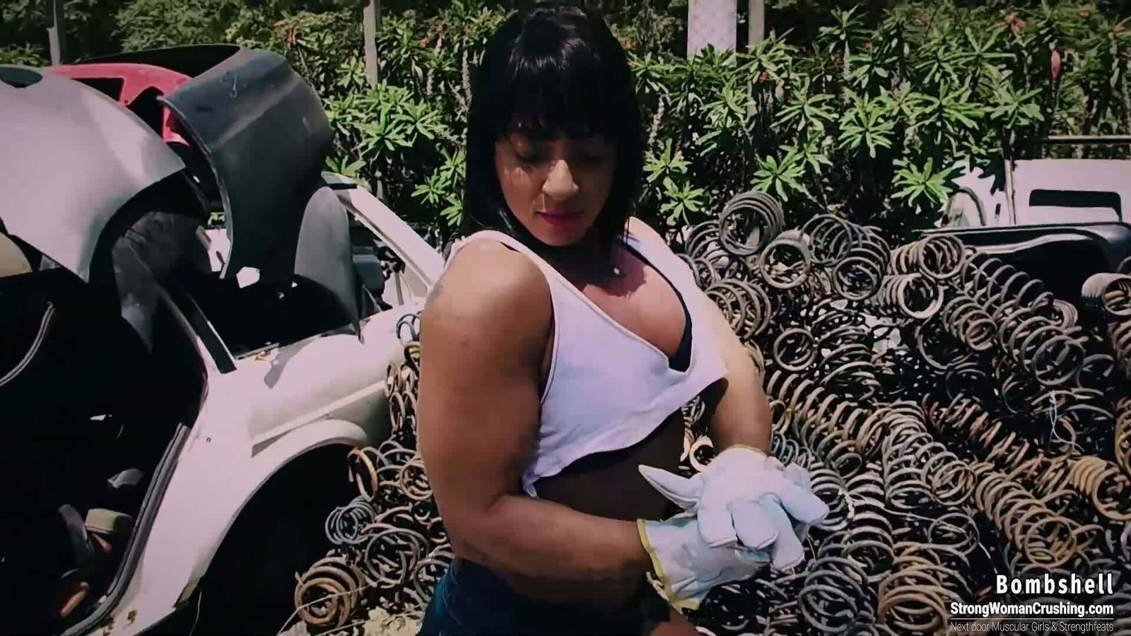 Album by MusclegirlStrength with the username @MusclegirlStrength, who is a brand user,  July 18, 2023 at 6:42 PM and the text says '#StrongWoman #BombshellCrushing #LiftingCars #ScrapyardLift #PowerLifting 💪🏼 Check out this video of Bombshell lifting a car in a scrapyard! Get your membership now to watch the whole thing at StrongWomanCrushing.com 💪🏼'