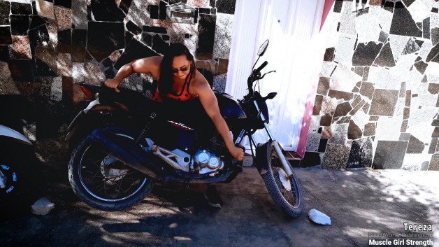Photo by MusclegirlStrength with the username @MusclegirlStrength, who is a brand user,  July 25, 2023 at 5:17 PM and the text says '💪🏼 Check out how Tereza lifts a Motorcycle and Scooter with ease! 📹 Visit StrongWomanCrushing.com to purchase a membership to watch the video! 🤩 #StrongWoman #CrushingGoals #PowerLifter #LiftLikeATereza #WomenWhoLift'