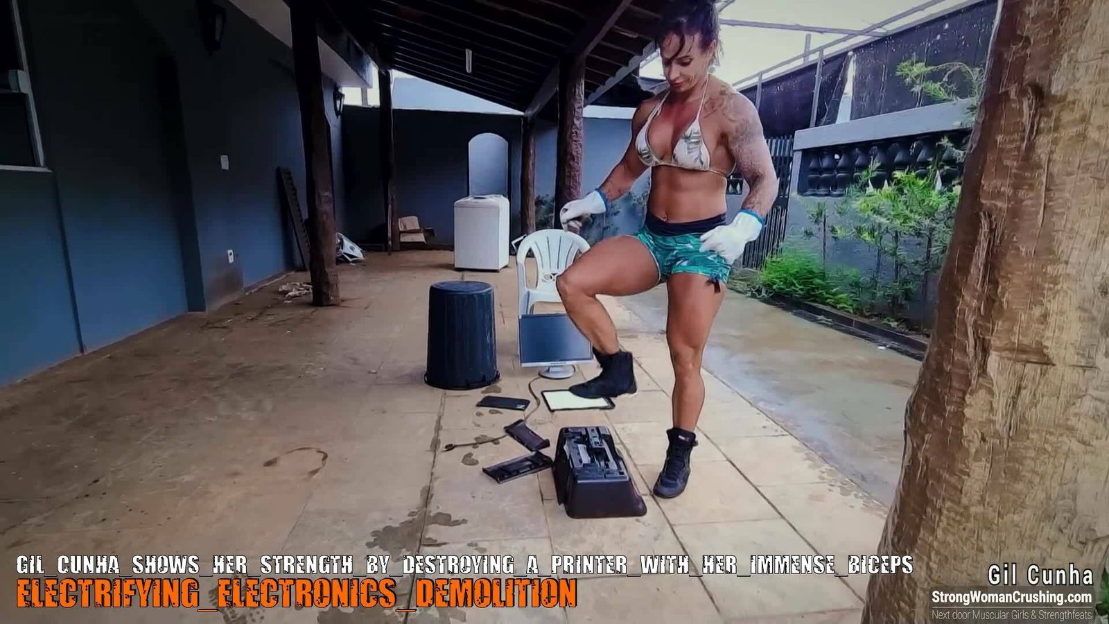 Album by MusclegirlStrength with the username @MusclegirlStrength, who is a brand user,  October 8, 2023 at 1:41 PM and the text says '🔥💪 Ready to witness pure power? Join us at www.strongwomancrushing.com and watch Gil Cunha unleash her strength as she obliterates a printer with her massive biceps! 💥🖨️ Don't miss out on this jaw-dropping display of female strength! 💪🔥..'