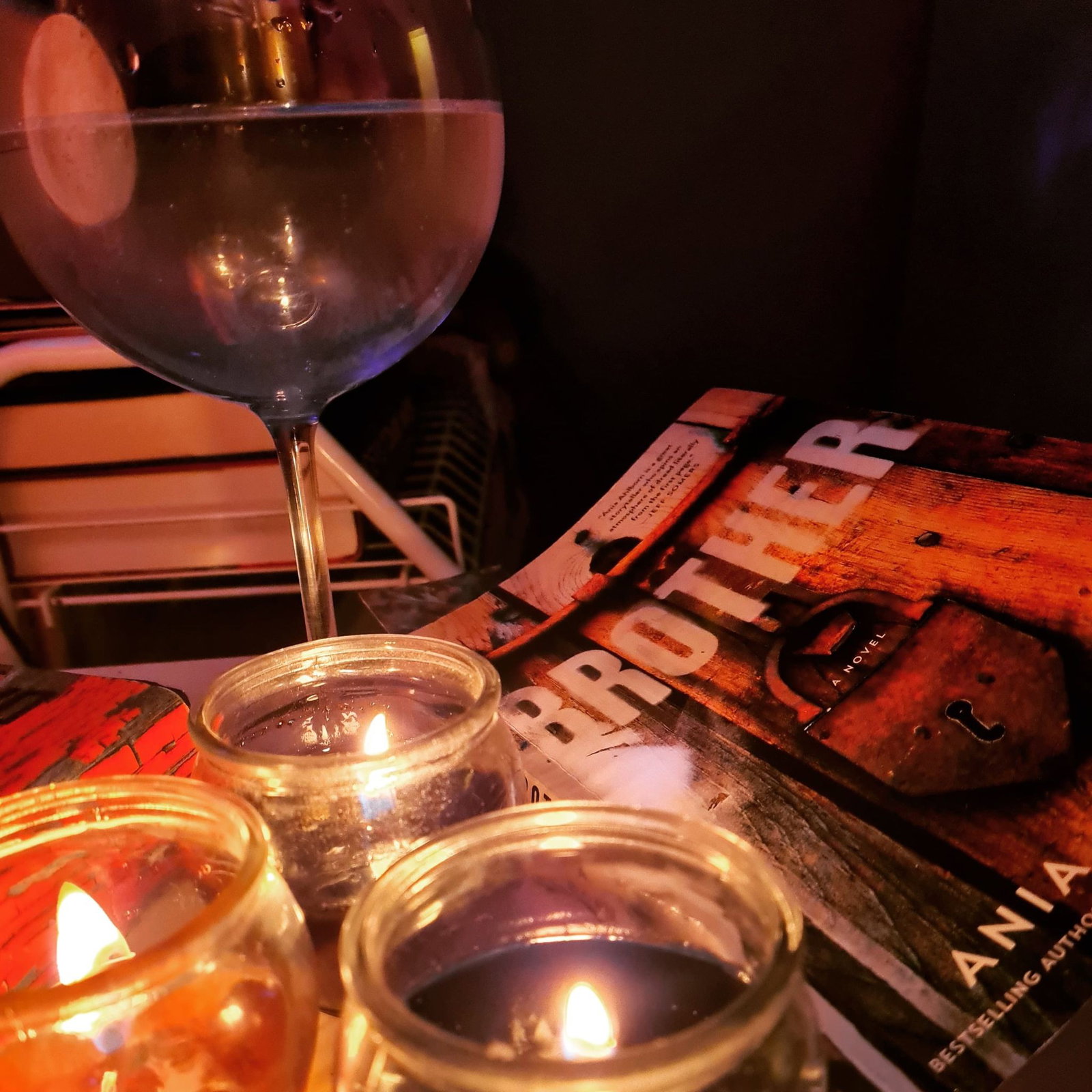 Photo by bonnie.darko with the username @bonnie.darko,  November 5, 2020 at 8:43 PM and the text says 'would you believe this is how I prefer to spend my evenings, candlelight; a good book and a large glass of gin.. Would you like posts like this of my genuine self too? Would that feel personalised? Let me know'